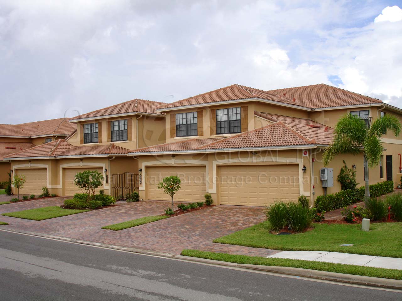 HERITAGE BAY waterfront coach homes with tile roofs, pavered drive and 2-car attached garages