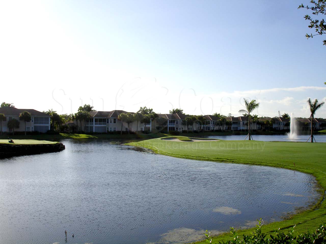Juliana Village waterfront coach homes with tile roofs and attached garages.